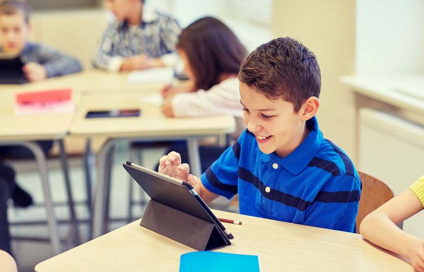 This a picture of a student completing an assignment using a tablet. The student looks engaged.